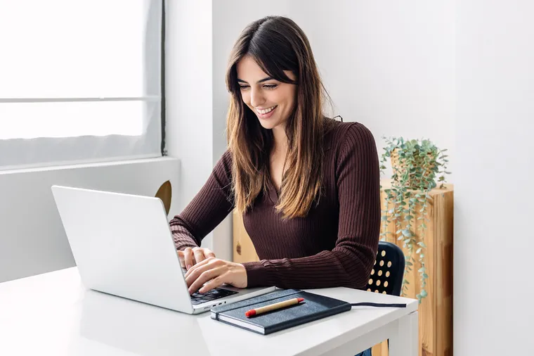 confident-young-adult-businesswoman-working-on-lap-2023-11-27-05-36-09-utcLR